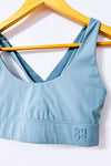 Brassière de sport bleu sauge à dos croisé seconde main - Sabē- La Penderie du Paradis