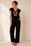 Jumpsuit noir avec billes blanches, noire et or à nouer