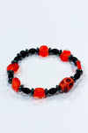 Bracelet billes noires et orange avec tête de mort seconde main Autres 