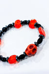 Bracelet billes noires et orange avec tête de mort seconde main Autres 