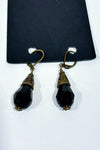 Boucles d’oreilles pendantes dorées à pierres noires facettées seconde main - Autres- La Penderie du Paradis