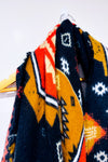 Écharpe oversized en tricot noir et orange à motifs géométriques seconde main - Misk- La Penderie du Paradis